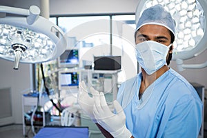Portrait of male surgeon standing in operation theater