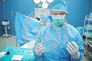 Portrait of male surgeon standing in operation theater