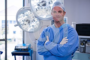 Portrait of male surgeon standing in operation theater photo