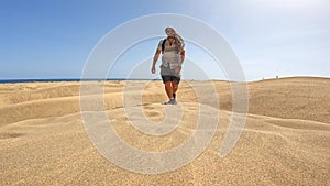 Portrait of male tourist in summer in the dunes of Maspalomas, Gran Canaria