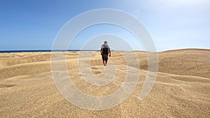 Portrait of male tourist in summer in the dunes of Maspalomas, Gran Canaria