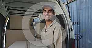 Portrait of male van driver with a warehouse delivery