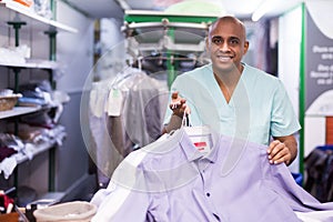 Portrait of male worker of dry-cleaning facility