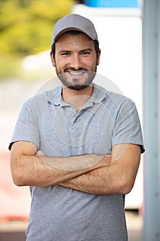 portrait male worker wearing gret polo shirt and cap