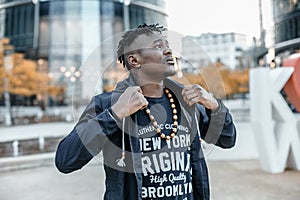 Portrait man African American attractive profile in the street. Fashion african man wearing jeans jacket poses on city. african