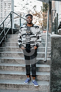 Portrait man African American attractive profile in the street. Fashion african man wearing jeans jacket poses on city. african