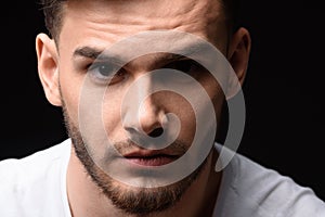 Portrait of man against black background