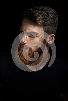 Portrait of a man with beard and modern hairstyle