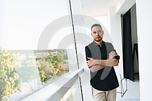 Portrait of a man in black shirt posing in photostudio