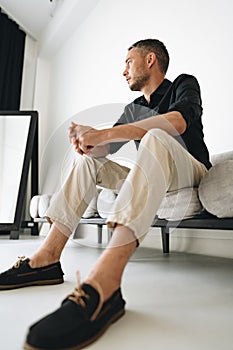 Portrait of a man in black shirt posing in photostudio