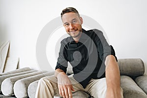 Portrait of a man in black shirt posing in photostudio