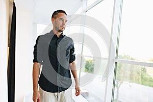 Portrait of a man in black shirt posing in photostudio