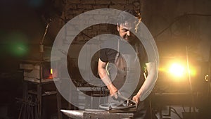 Portrait of a man of a blacksmith in the working atmosphere.