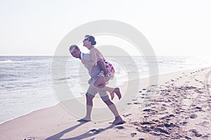 Portrait of man carrying girlfriend