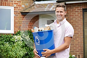 Portrait Of Man Carrying Recycling Bin