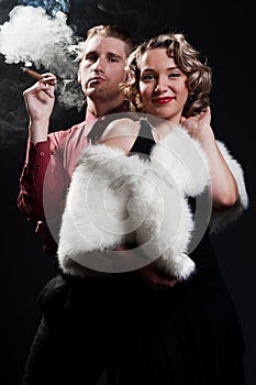 Portrait of man with cigar and chic woman