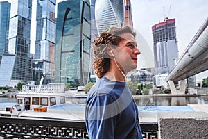 Portrait of man in the city on the background of large buildings complex Moscow-city, skyscrapers in the center of