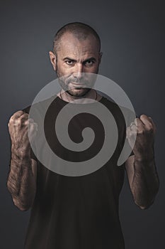 Portrait of man with clenched fists as a sign of victory