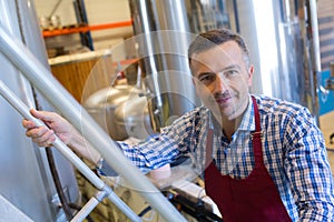 Portrait man climbing staircase in distillery