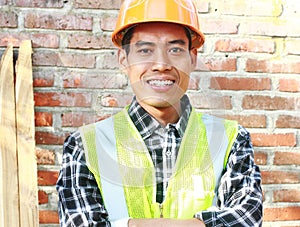 Portrait of man construction worker standing front of wall construction