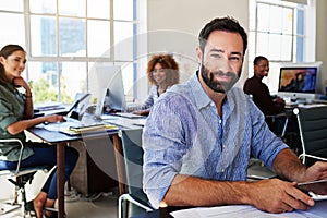 Portrait of man in creative agency with leadership, confidence and success at design startup. Happy business people in