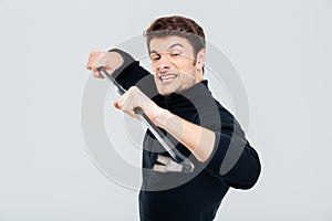 Portrait of man criminal burglar using crowbar