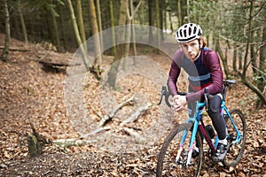 Portrait of man cross-country cycling in a forest, close up