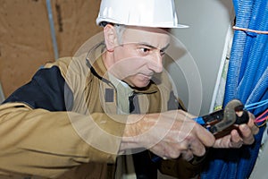 portrait man cutting wires