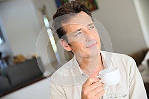 Portrait of a man drinking coffee at home