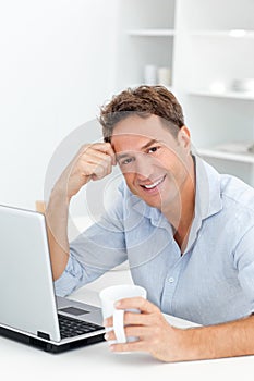 Portrait of man drinking coffee while working