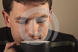 Portrait of man drinking hot beverage