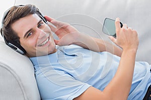 Portrait of a man enjoying music with his smartphone