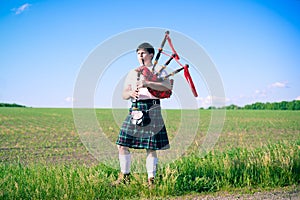 Portrait of man enjoying playing pipes in Scottish