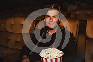 Portrait of a man enters the movie with popcorn.