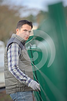 Portrait man erecting garden fence