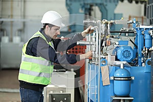 Portrait of a man , factory engineer in work clothes controlling the work process