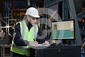 Portrait of a man , factory engineer in work clothes controlling the work process at the airplane manufacturer.