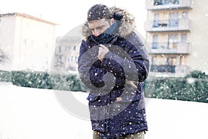 Portrait of man feeling very cold under snowy weather