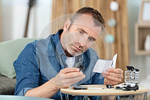 portrait man fixing camera