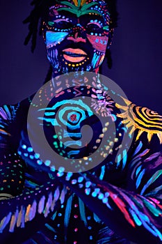 Portrait of man in fluorescent body art