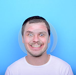 Portrait of man with funny face against blue background