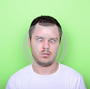 Portrait of man with funny face against green background