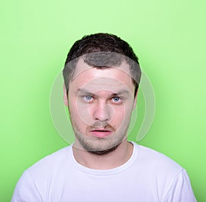 Portrait of man with funny face against green background