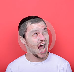 Portrait of man with funny face against red background