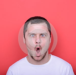 Portrait of man with funny face against red background