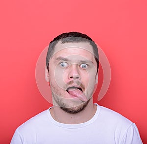 Portrait of man with funny face against red background