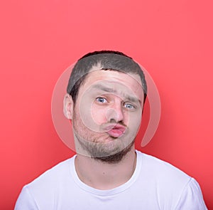 Portrait of man with funny face against red background