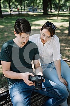 Portrait of man and girl looking at professional camera outdoor