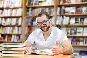 Portrait of a man with glasses in a bookstore