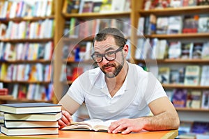 Portrait of a man with glasses in a bookstore